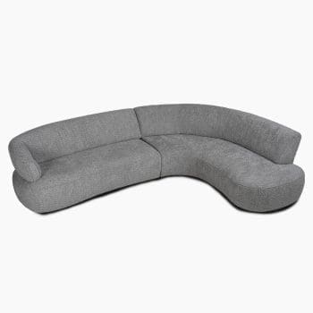 Ronde hoekbank bij Houweling Interieur. Het is een lounge bank met zachte vormen, uitgevoerd in grijze stof.