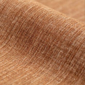 Meubelstoffen bij Houweling Interieur. Moss meubelstof van De Ploeg stoffen met natuurlijke kleurenmix in zalmkleur.