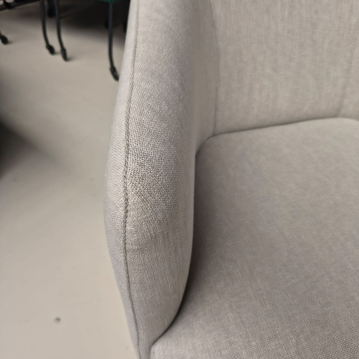 Showroommodel van een moderne fauteuil van Olta bij Houweling Interieur. Design fauteuil uitgevoerd in crème stof.