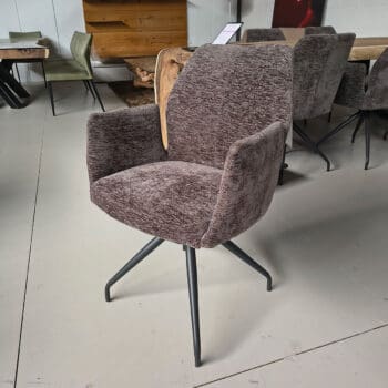 Showroommodel van luxe eetkamerstoel bij Houweling Interieur. Moderne eetkamerstoel uitgevoerd in bruin stof en spinpoot.